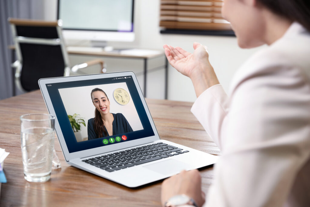 Woman on laptop on a virtual meeting getting resume assistance.