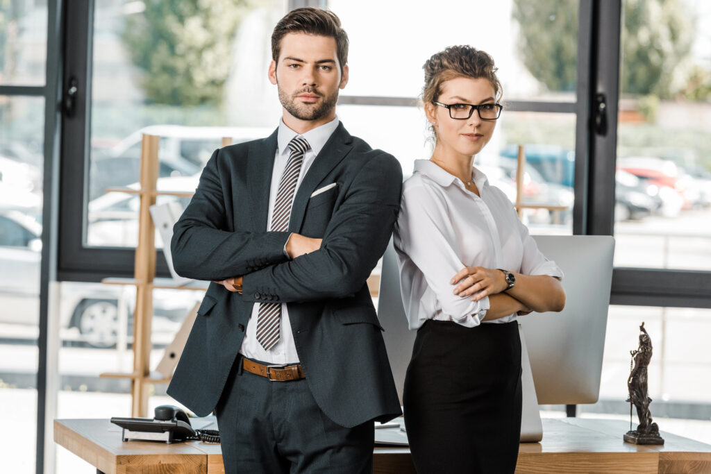 Business man and woman standing back to back.