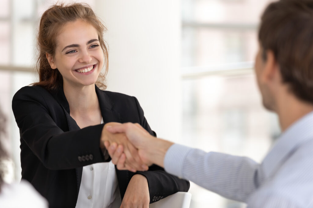 woman shaking hands with interviewer after job interview