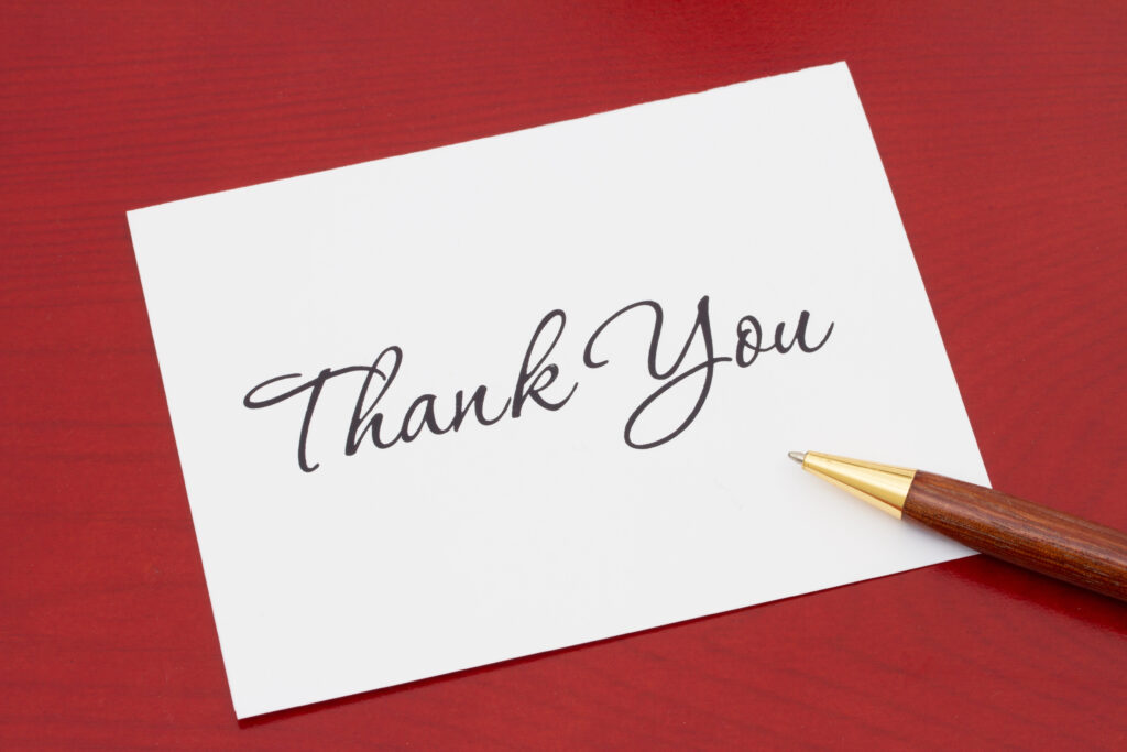 Handwritten thank you note on a red background.