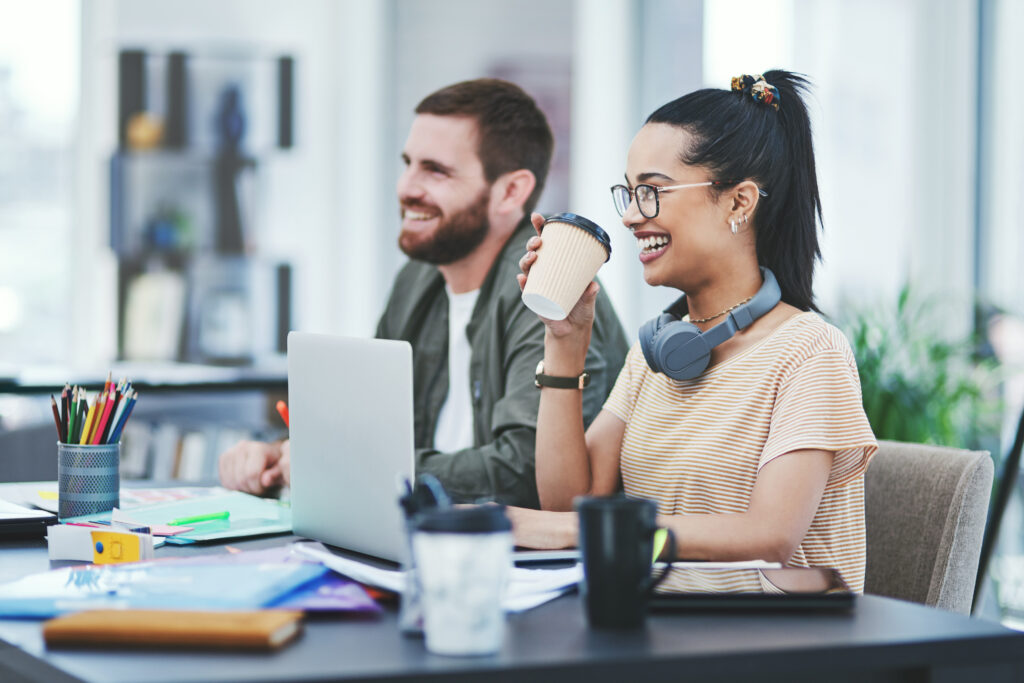 Man and woman laughing and talking during interview meeting.