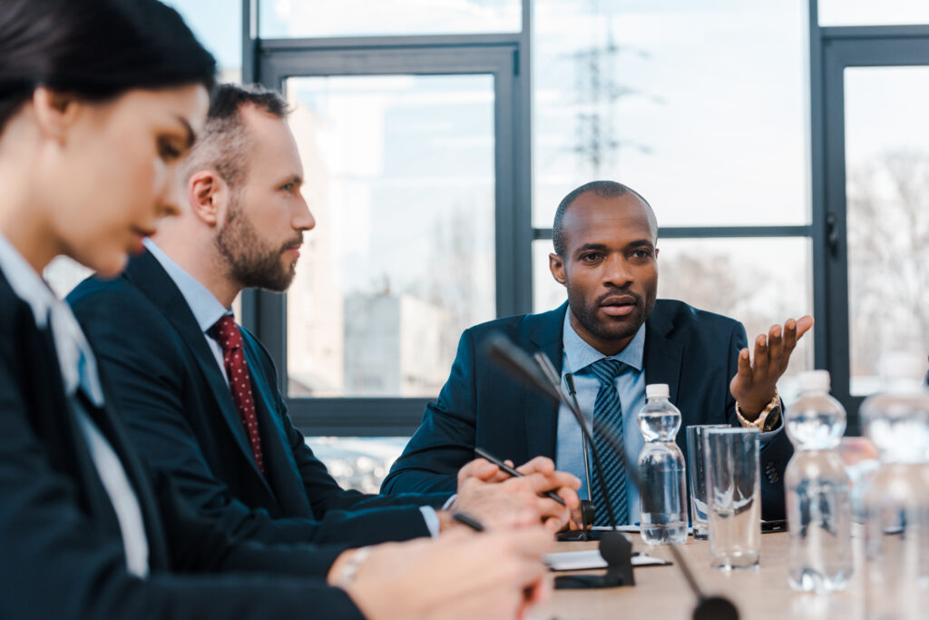 Man speaking confidently answering questions at the end of an interview. 