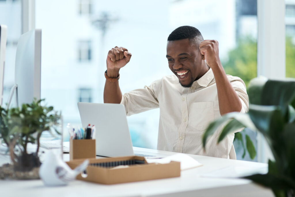 Man celebrating after sending thank you email after interview.