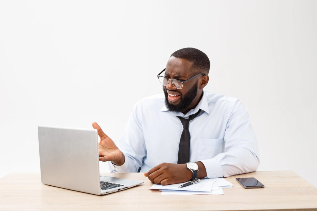 Angry man on video call on laptop.