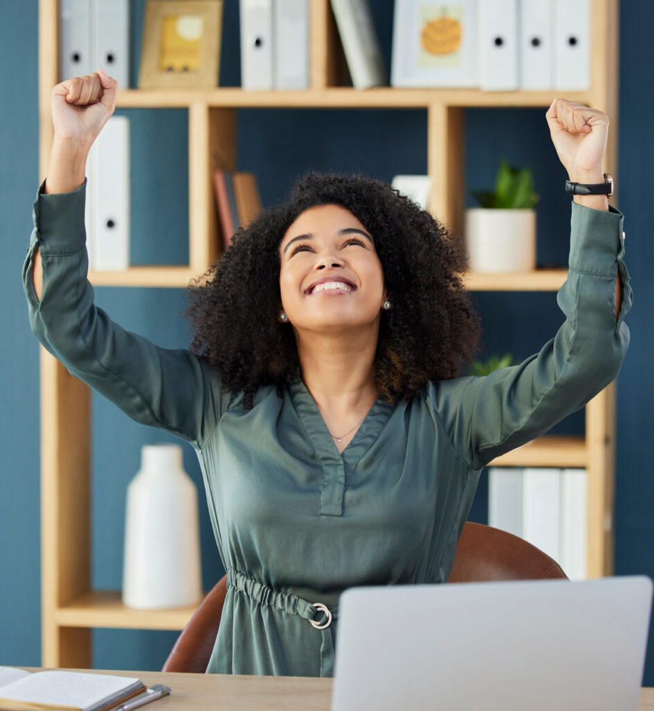 Woman celebrating with her hands int he air after figuring out how to accept a job offer.