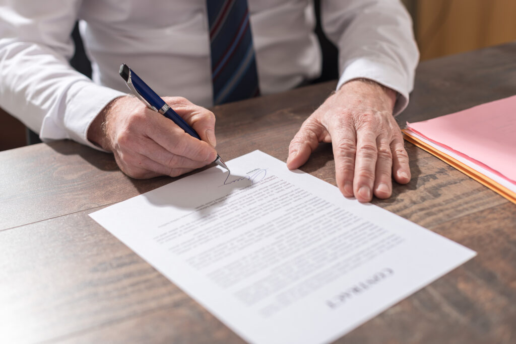 Businessman signing a 2 week notice letter